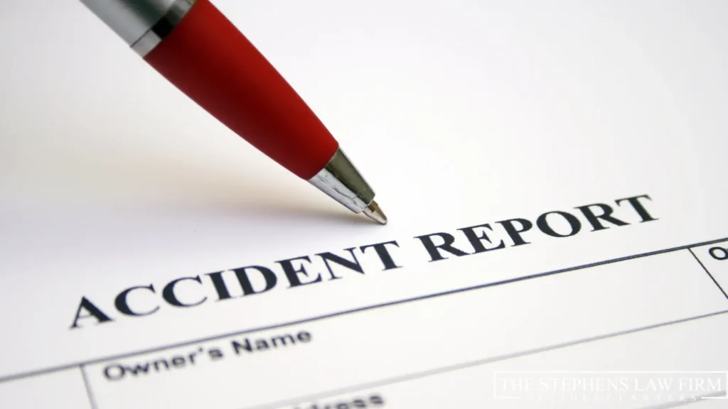 An image of an accident report written on a sheet of white paper with a pen placed near it