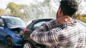 man holding his neck, near an auto accident in Katy, TX