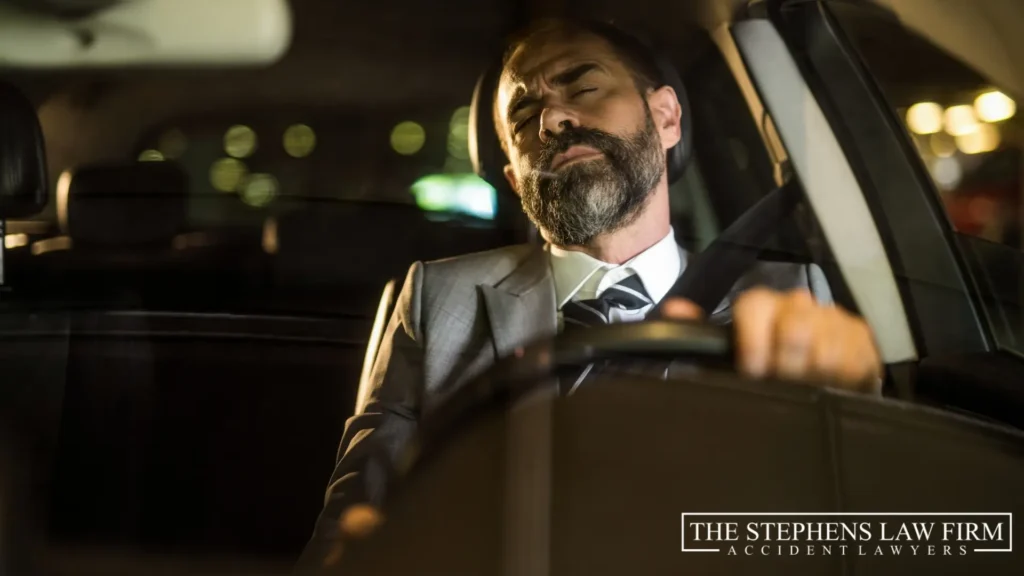man sleeping behind the wheel