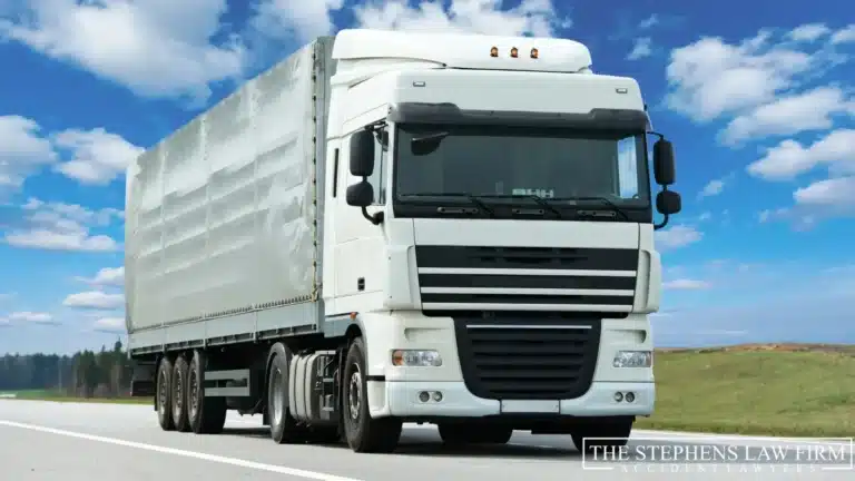 An image of a truck trailer driving on the road.