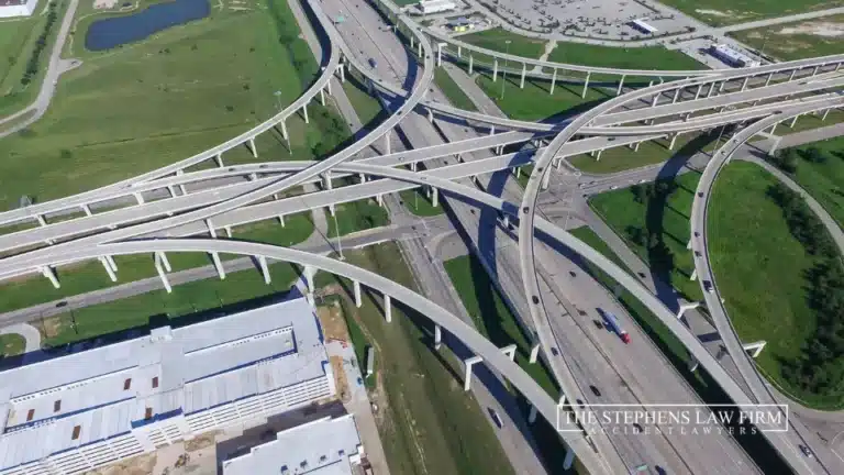 Aerial view of a complex highway intersection featuring multiple lanes and vehicles in motion.