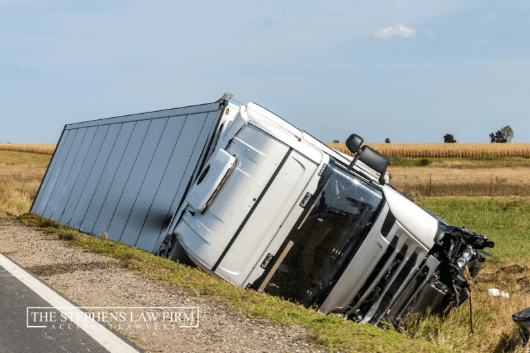 Semi Truck on the side of the road crashed on its side in an embankment